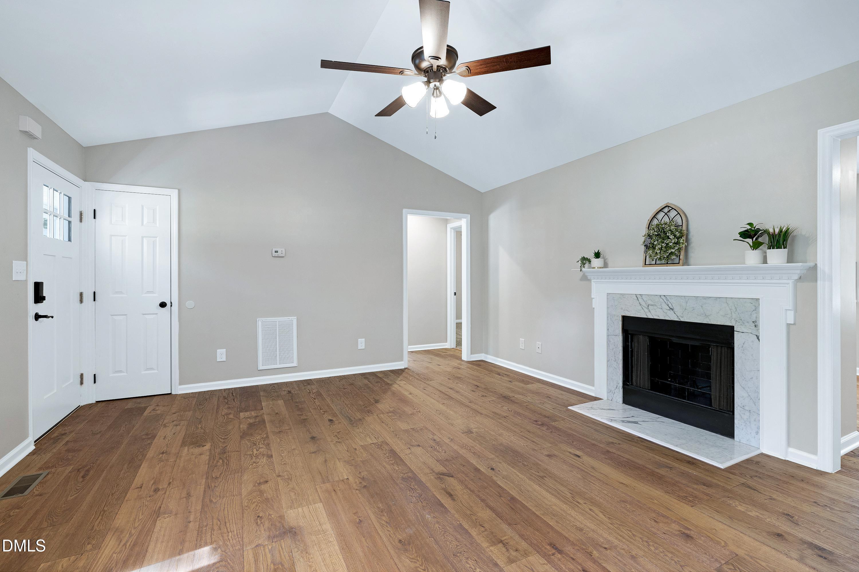 1508 Middle Ridge Drive Willow Spring, NC 27592 - Photo 8 of 56 a view of empty room with wooden floor and fireplace