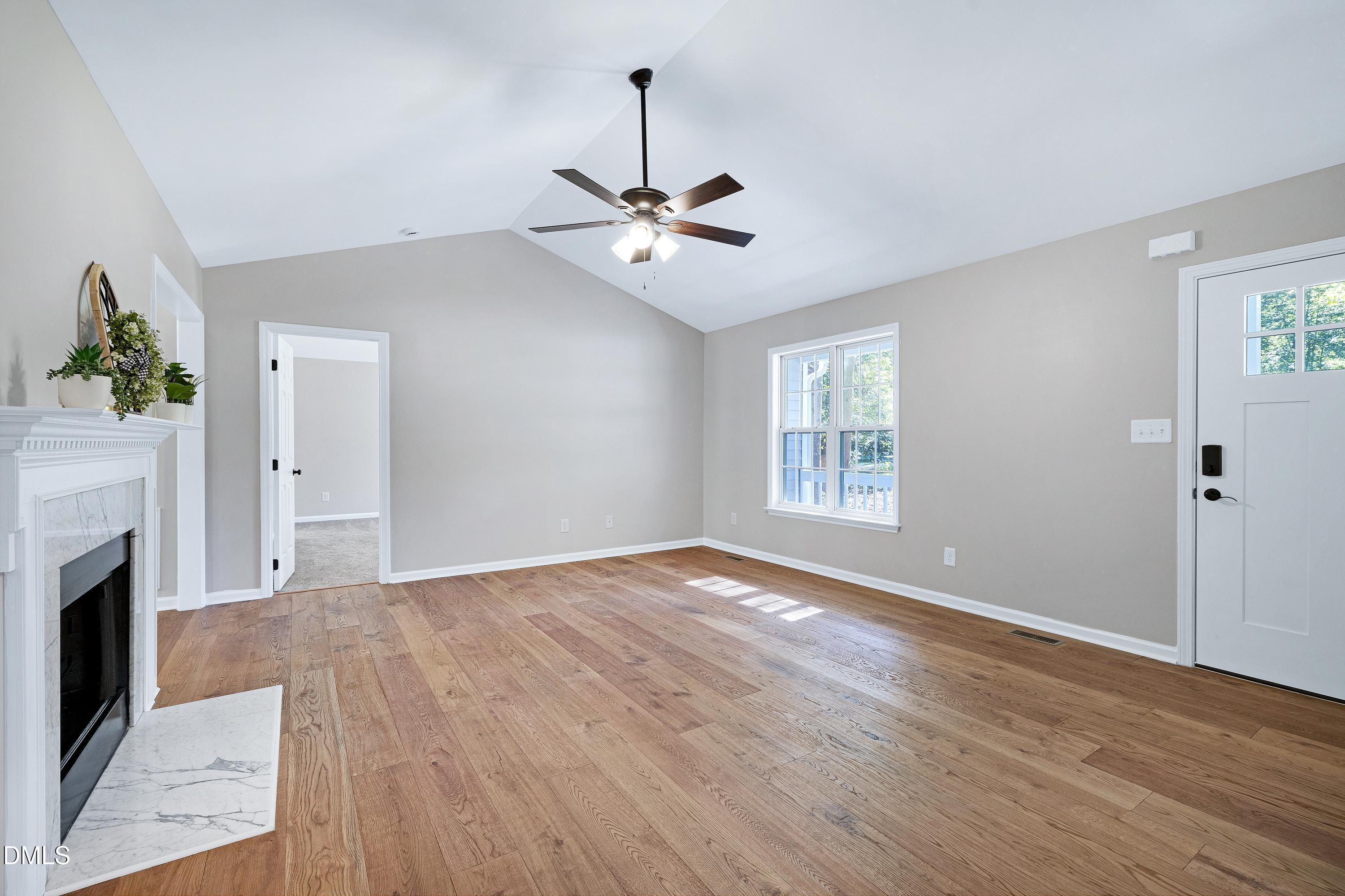 1508 Middle Ridge Drive Willow Spring, NC 27592 - Photo 10 of 56 a view of empty room with wooden floor and fan