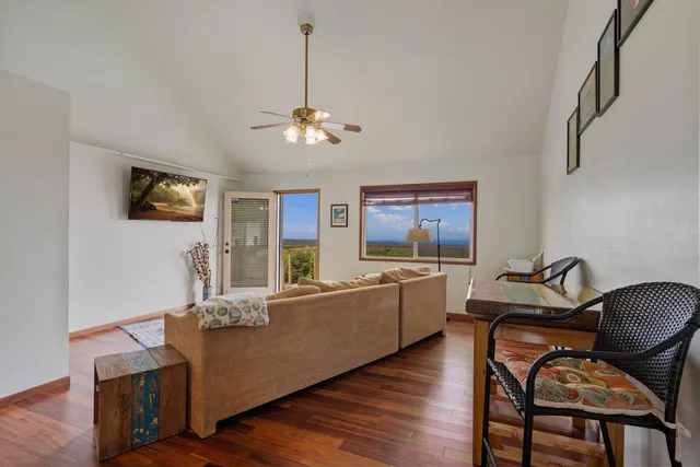 a living room with furniture flat screen tv and window