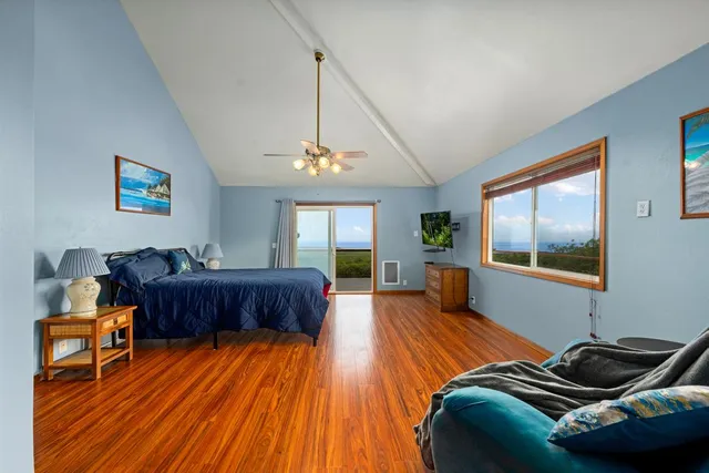 a bedroom with furniture and wooden floor