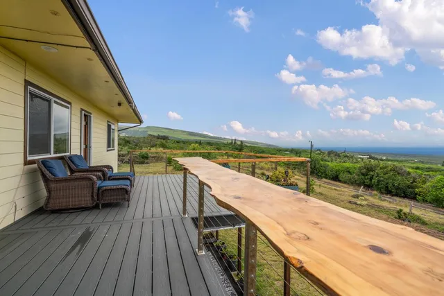 a view of roof deck with wooden floor and fence