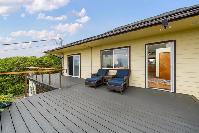 a view of a roof deck with wooden floor and seating space