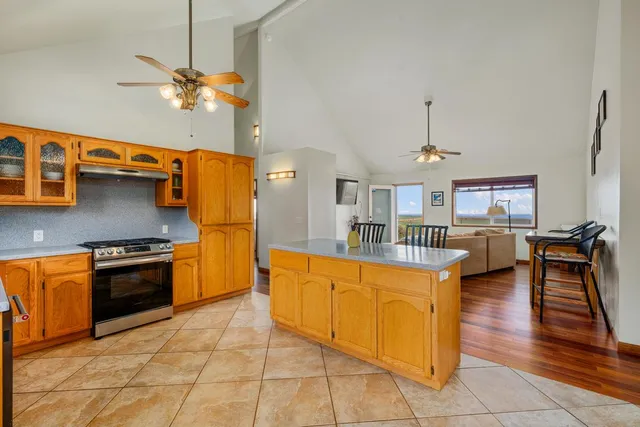a kitchen with stainless steel appliances granite countertop a stove a sink dishwasher and a refrigerator