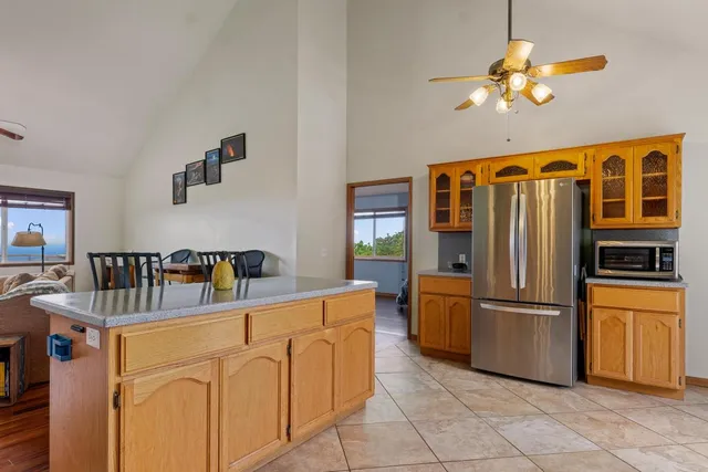 a kitchen with stainless steel appliances granite countertop a refrigerator a stove and a sink with cabinets