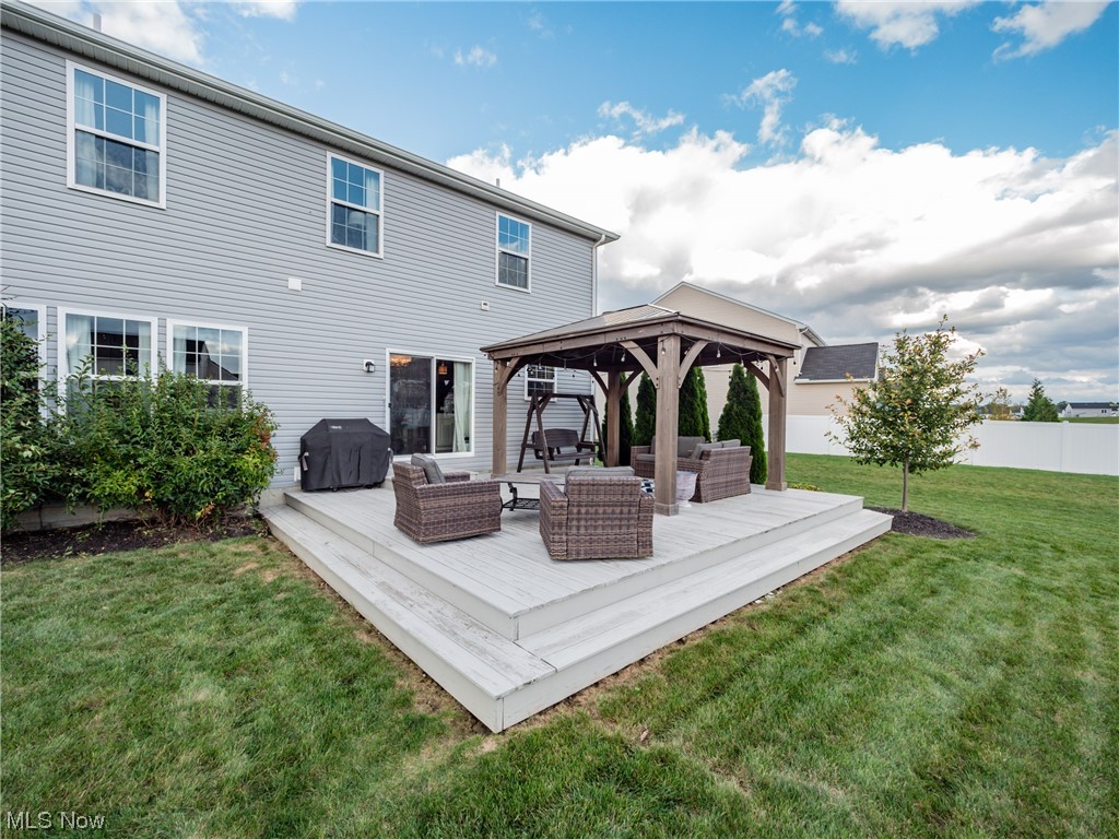 37571 Amber Way North Ridgeville, OH 44039 - Photo 29 of 35 Rear view of house featuring a gazebo, an outdoor hangout area, and a lawn