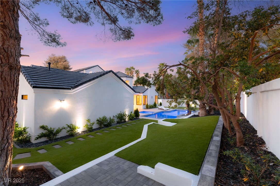 2316 Prometheus Court Henderson, NV 89074 - Photo 71 of 92 Yard at dusk with an outdoor pool, a fenced backyard, and a patio area