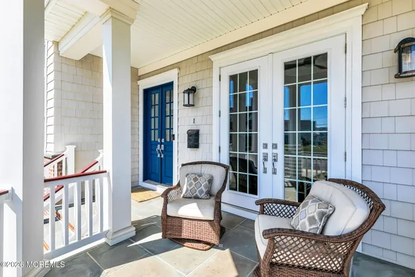 a balcony with furniture and front door