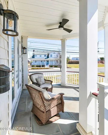 a balcony with furniture and a large window
