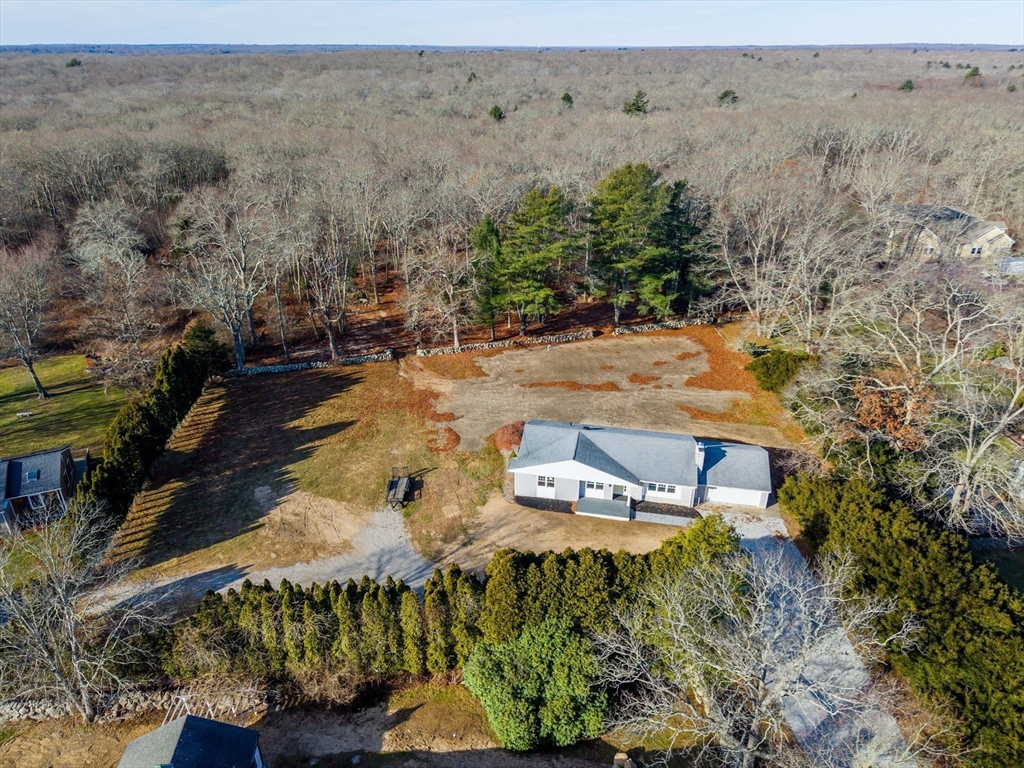 an aerial view of a house with a yard