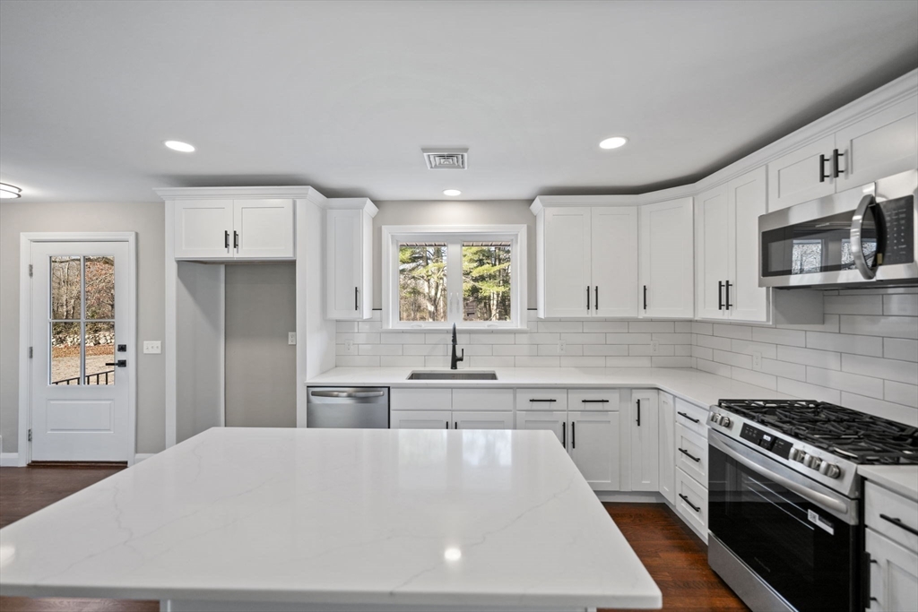 837 Main Road Westport, MA 02790 - Photo 5 of 18 a kitchen with kitchen island granite countertop a stove sink and refrigerator