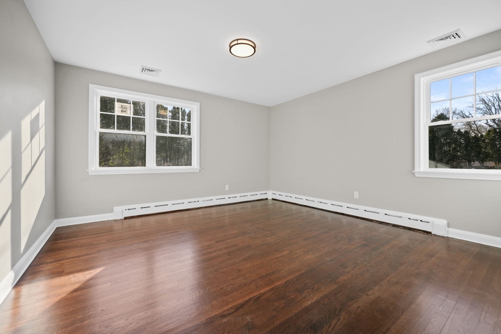 837 Main Road Westport, MA 02790 - Photo 9 of 18 an empty room with wooden floor and windows