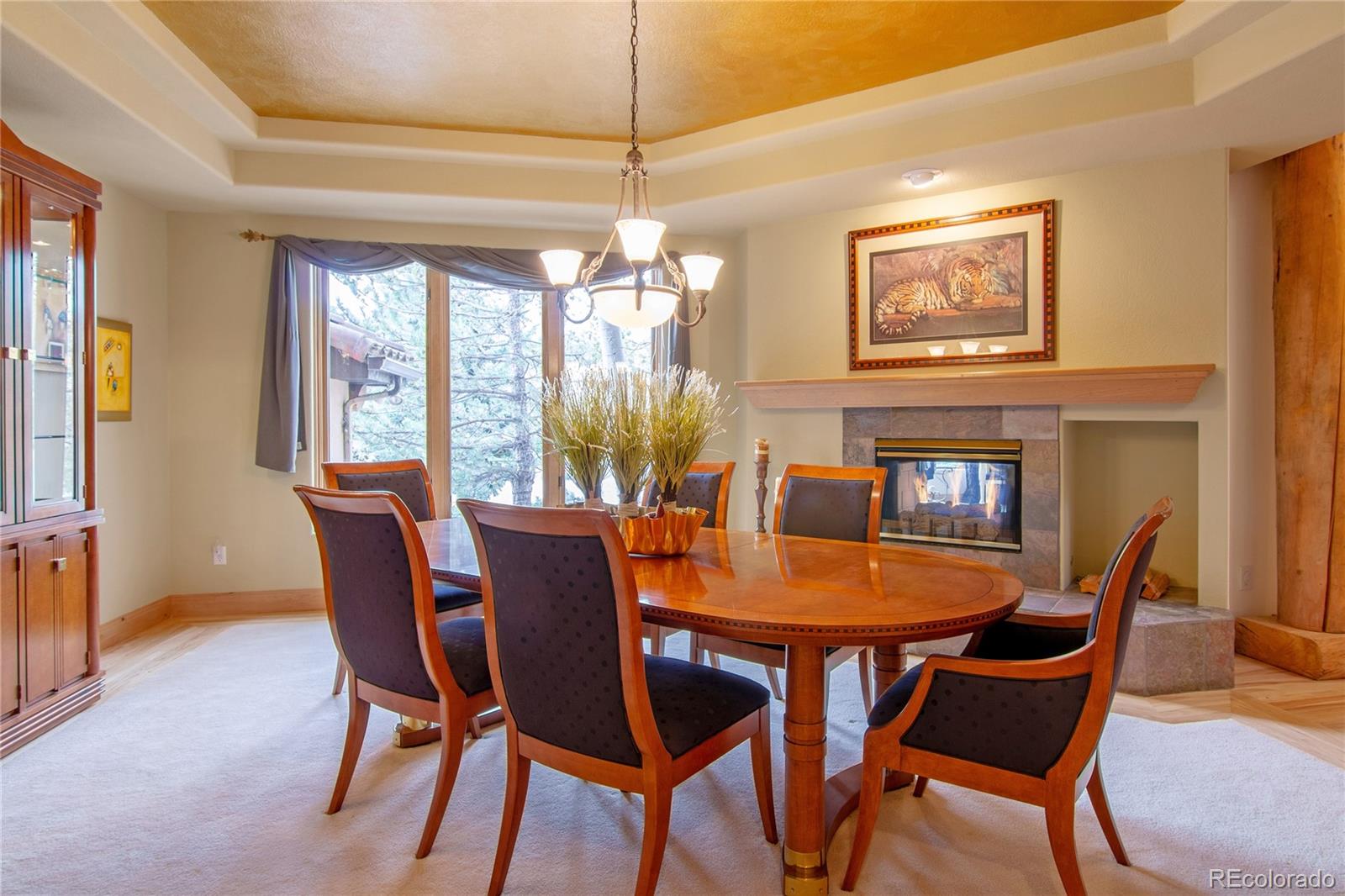974 Spring Ranch Drive Golden, CO 80401 - Photo 14 of 35 a dining room with furniture a chandelier and wooden floor