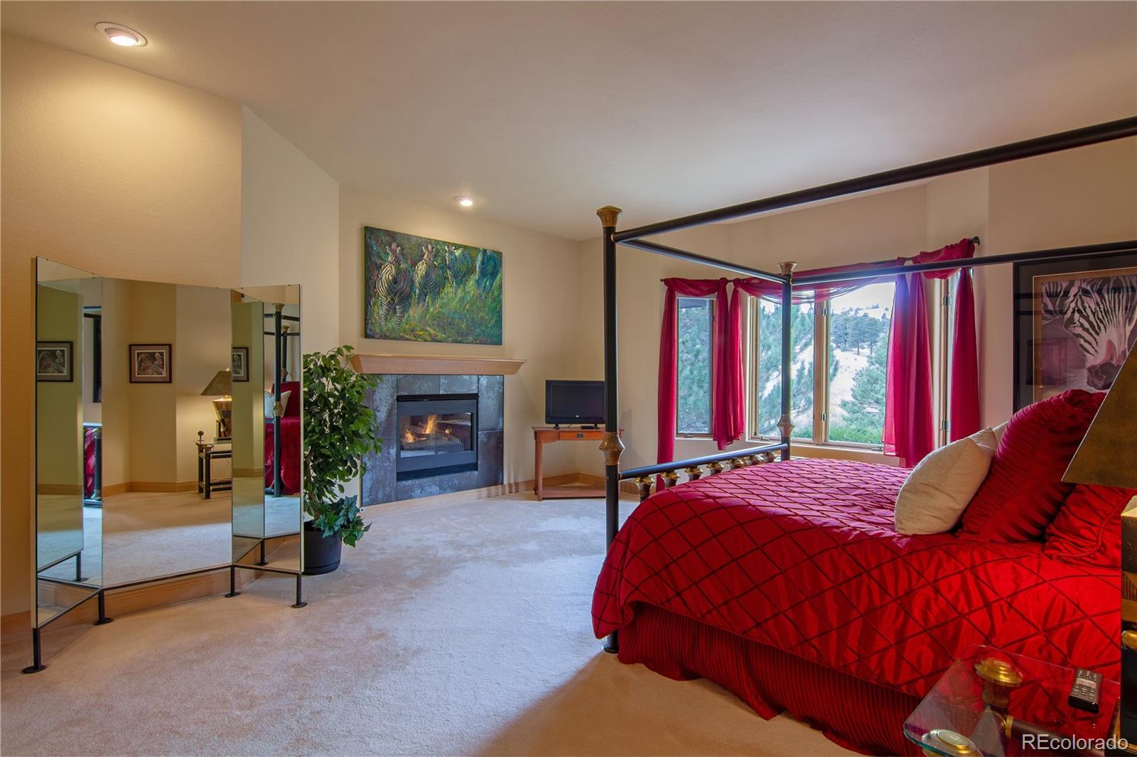 974 Spring Ranch Drive Golden, CO 80401 - Photo 15 of 35 a bedroom with bed and a fireplace