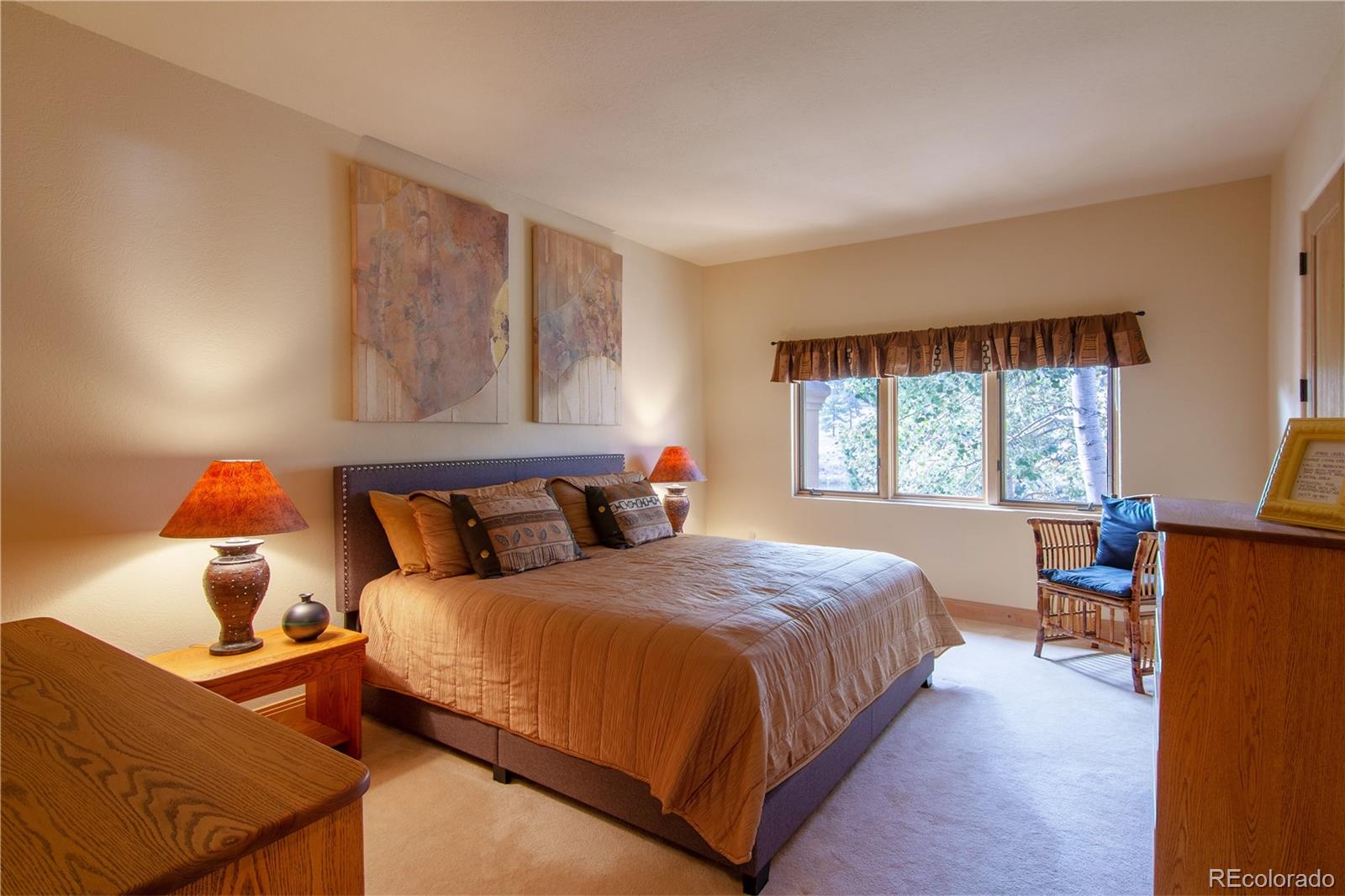 974 Spring Ranch Drive Golden, CO 80401 - Photo 19 of 35 a bedroom with a bed and window