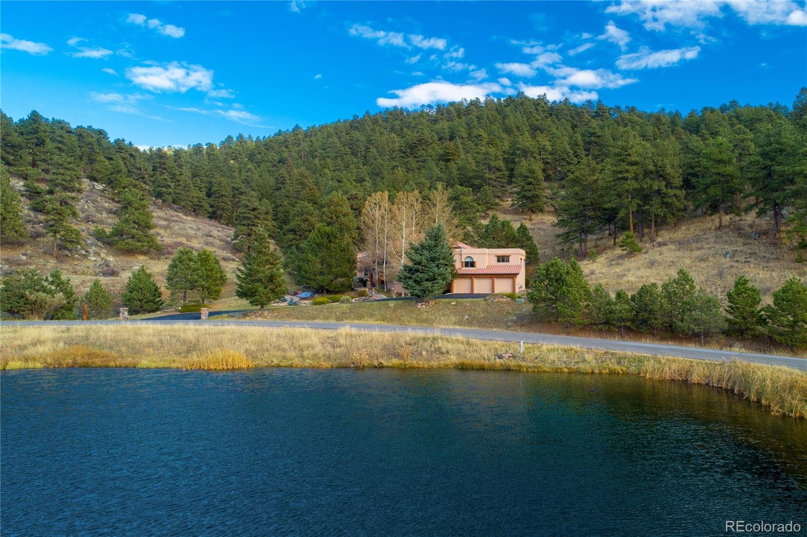 974 Spring Ranch Drive Golden, CO 80401 - Photo 2 of 35 a view of a lake with a yard