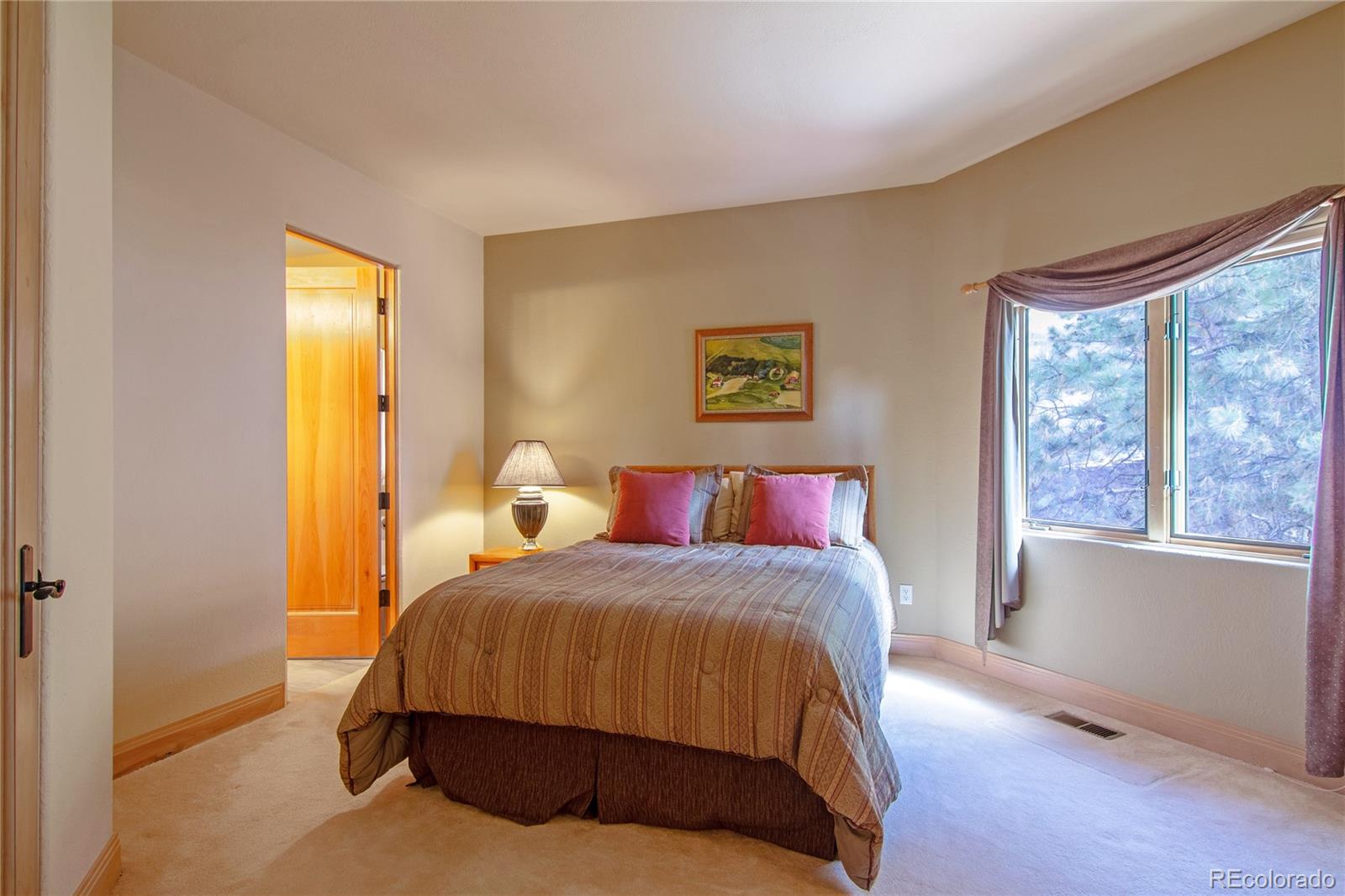 974 Spring Ranch Drive Golden, CO 80401 - Photo 21 of 35 a bedroom with a bed and wooden floor