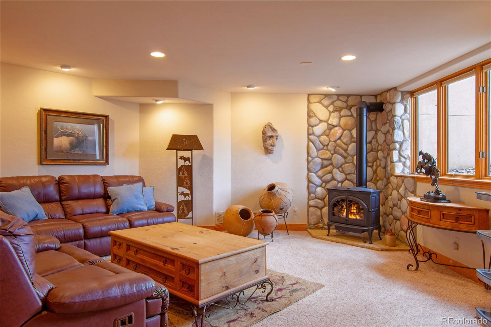 974 Spring Ranch Drive Golden, CO 80401 - Photo 24 of 35 a living room with furniture a flat screen tv and a fireplace