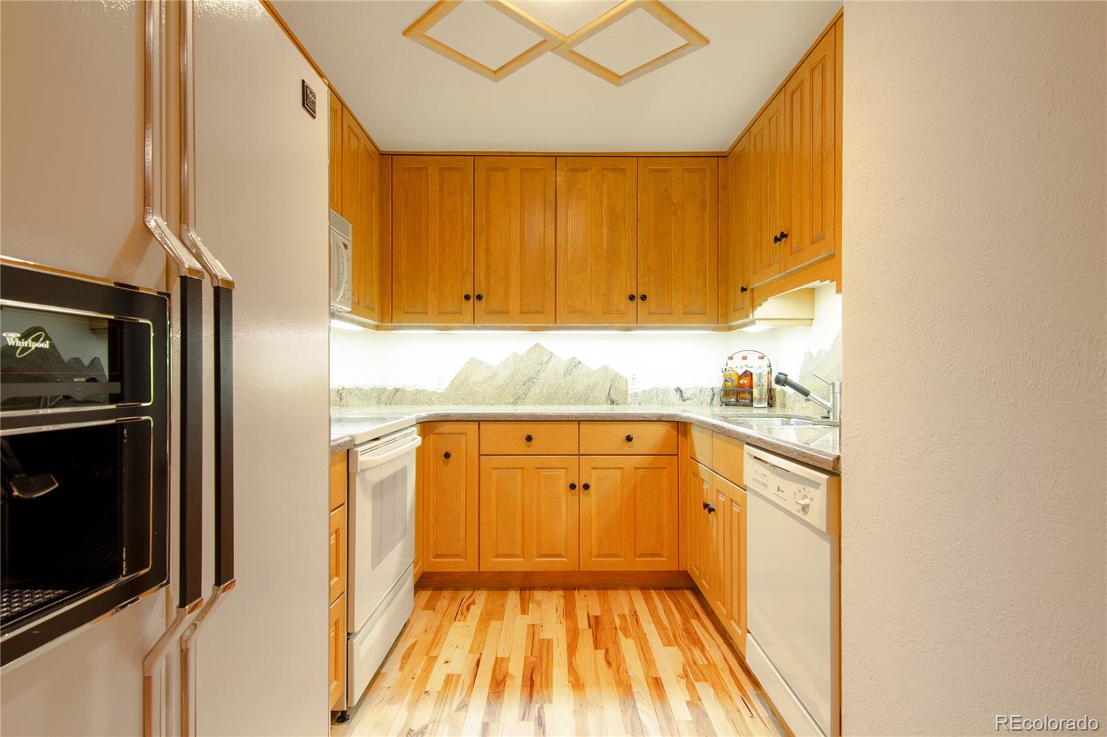 974 Spring Ranch Drive Golden, CO 80401 - Photo 26 of 35 a kitchen with granite countertop cabinets stainless steel appliances and a counter space