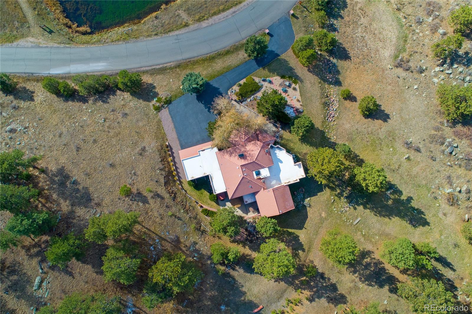 974 Spring Ranch Drive Golden, CO 80401 - Photo 32 of 35 an aerial view of a house with a yard