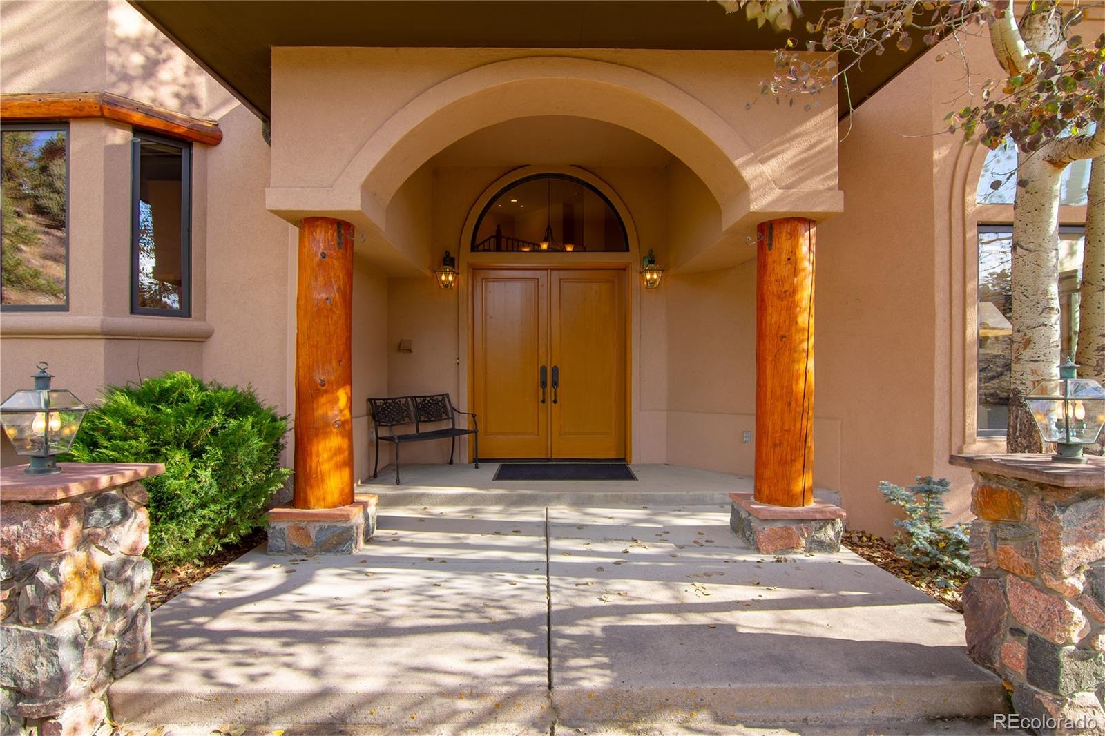 974 Spring Ranch Drive Golden, CO 80401 - Photo 4 of 35 a view of a house with large windows and a small yard