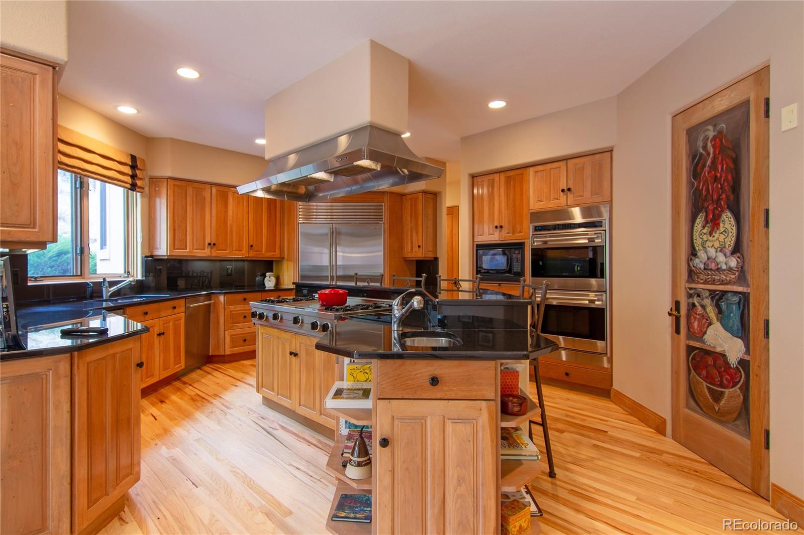974 Spring Ranch Drive Golden, CO 80401 - Photo 8 of 35 a kitchen with stainless steel appliances granite countertop a stove and a refrigerator