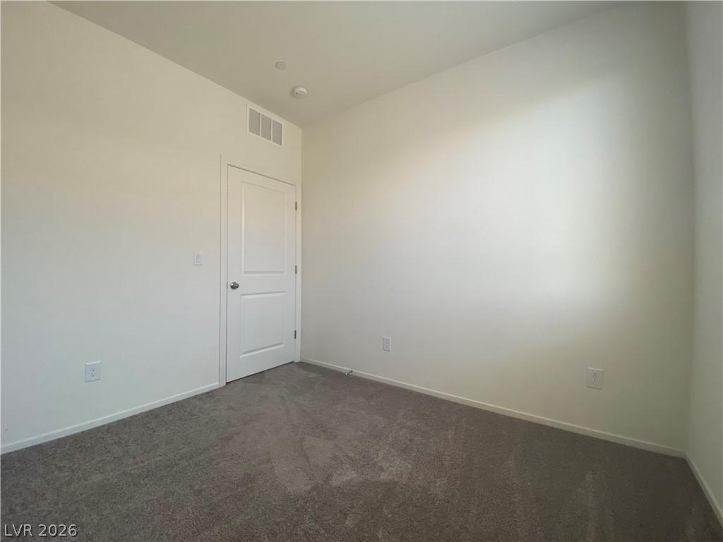 436 Cadence View Way Henderson, NV 89011 - Photo 23 of 36 A spacious room offers comfortable carpet flooring and ample wall space for personalization.