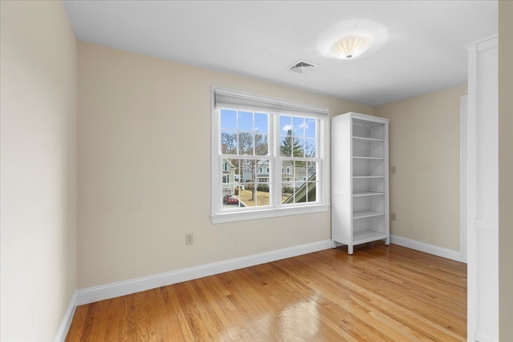 11 Shirley Road Needham, MA 02494 - Photo 18 of 41 an empty room with wooden floor and windows