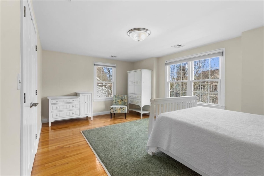 11 Shirley Road Needham, MA 02494 - Photo 19 of 41 a bedroom with a bed and wooden floor