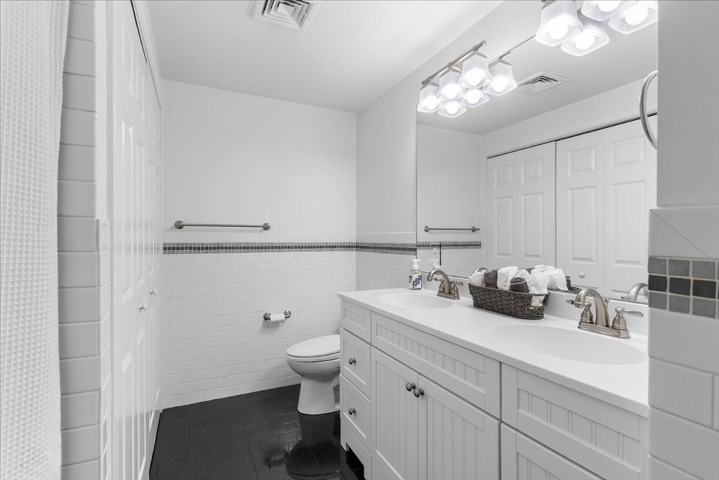 11 Shirley Road Needham, MA 02494 - Photo 23 of 41 a bathroom with a toilet sink and mirror