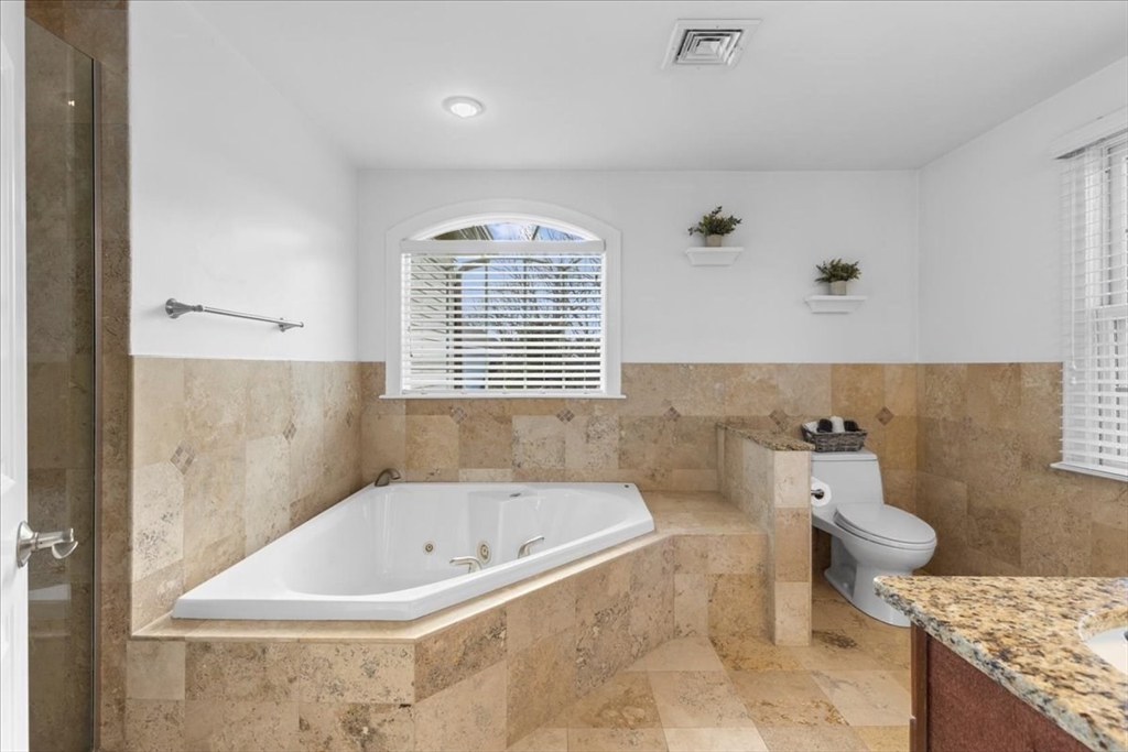 11 Shirley Road Needham, MA 02494 - Photo 27 of 41 a bathroom with a granite countertop sink a toilet and bathtub