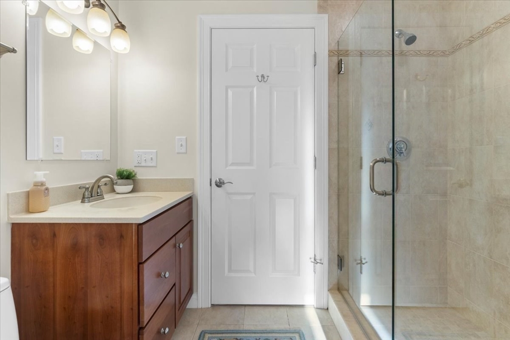 11 Shirley Road Needham, MA 02494 - Photo 10 of 41 a bathroom with a sink vanity granite shower and a mirror
