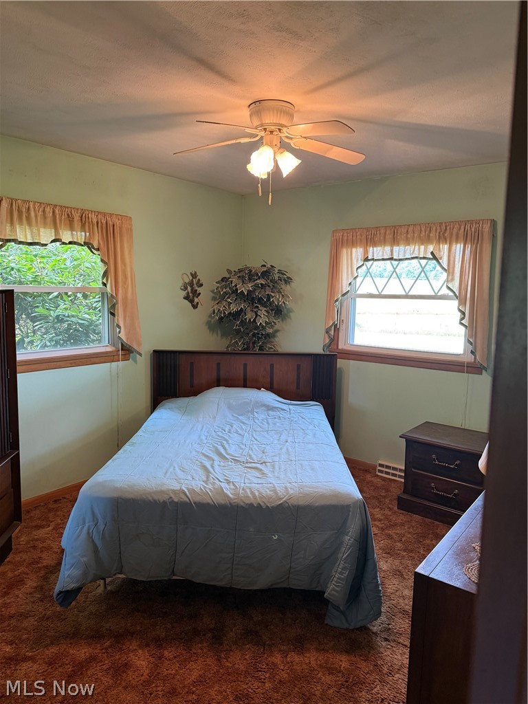 10993 Claridon Troy Road Chardon, OH 44024 - Photo 10 of 20 Bedroom featuring light green walls and textured carpeting