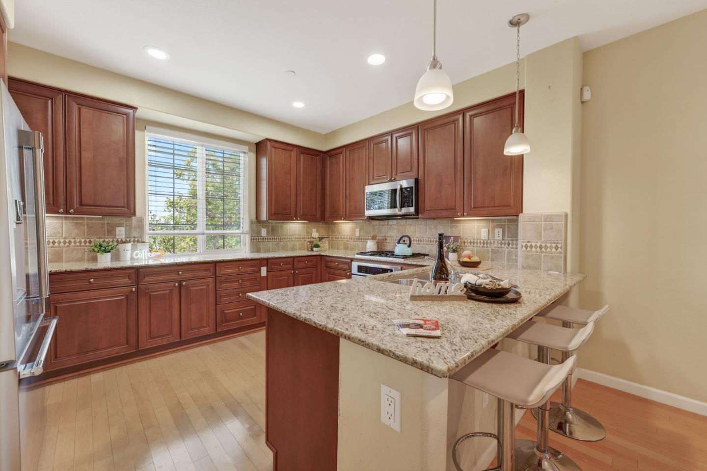 1030 Luz Del Sol Tr Loop Milpitas, CA 95035 - Photo 4 of 26 a kitchen with a stove a sink a refrigerator and cabinets