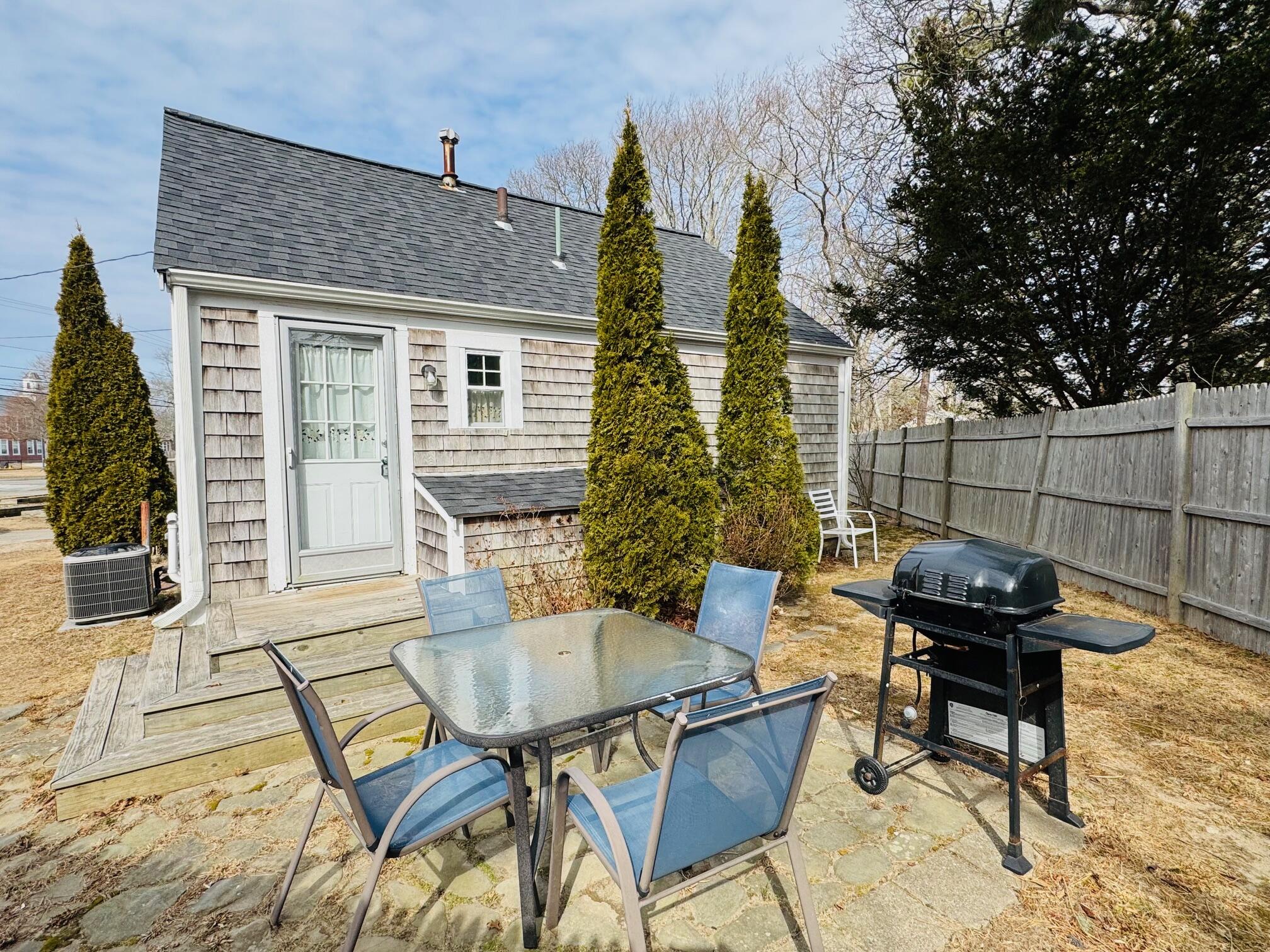 120 Bearses Way Hyannis, MA 02601 - Photo 8 of 11 a backyard of a house with barbeque oven table and chairs