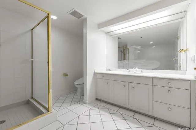 a spacious bathroom with a granite countertop sink mirror and toilet