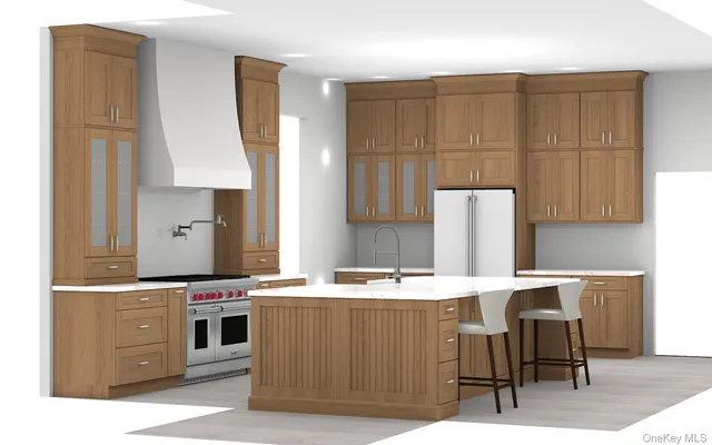 a room with stainless steel appliances kitchen island granite countertop a sink a stove and a refrigerator