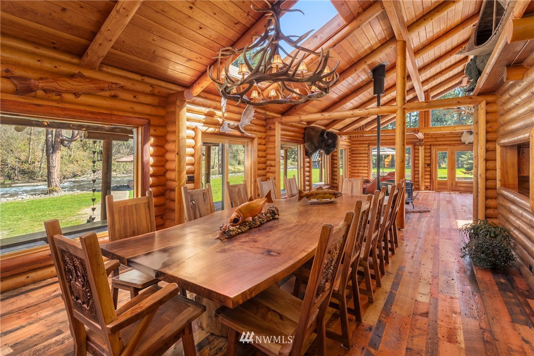 18700 Byers Road Southeast Maple Valley, WA 98038 - Photo 13 of 40 a view of a dining room with furniture a chandelier and wooden floor