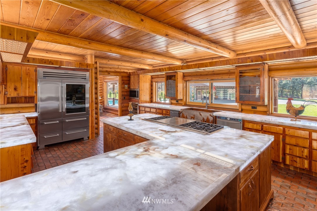 18700 Byers Road Southeast Maple Valley, WA 98038 - Photo 17 of 40 a dining hall with stainless steel appliances granite countertop a sink and cabinets