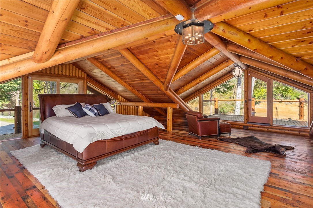 18700 Byers Road Southeast Maple Valley, WA 98038 - Photo 18 of 40 a bedroom with a bed and wooden floor