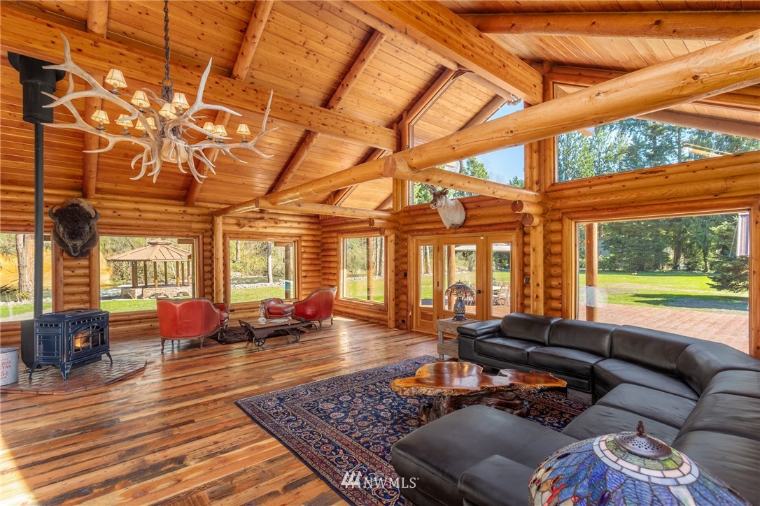 18700 Byers Road Southeast Maple Valley, WA 98038 - Photo 8 of 40 a living room with furniture floor to ceiling window and wooden floor