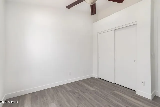 a view of a room with wooden floor