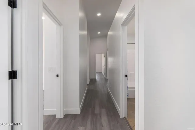 a view of a hallway with wooden floor