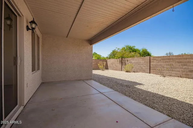 an empty room with wooden floor closet and windows