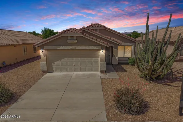 a view of a house with a snow in the background