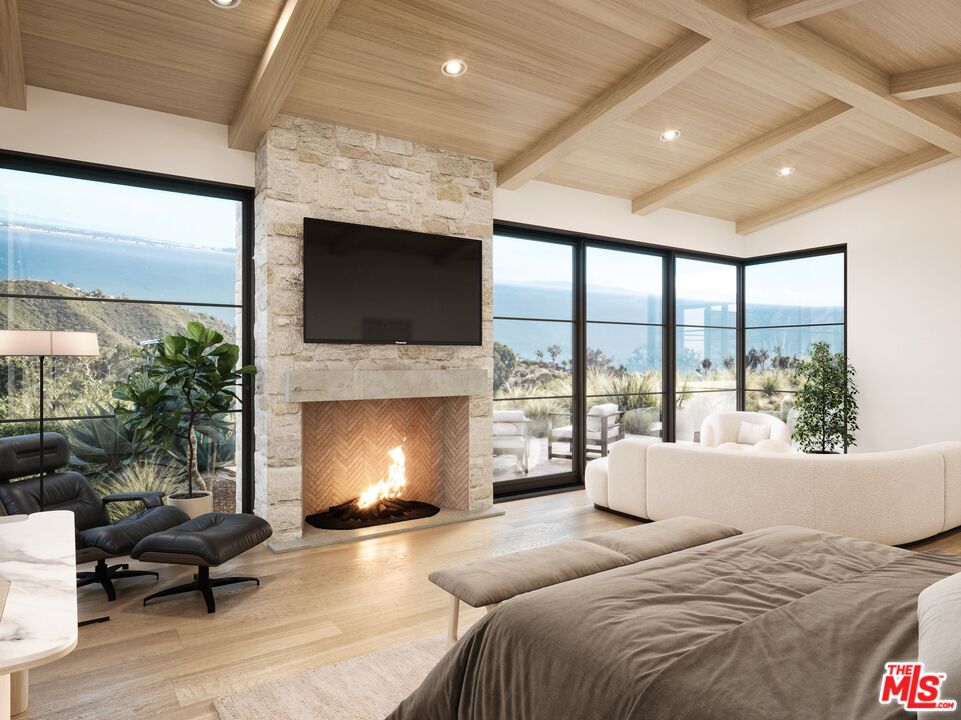 3140 Sumac Ridge Road Malibu, CA 90265 - Photo 9 of 17 a bedroom with a bed and a fireplace