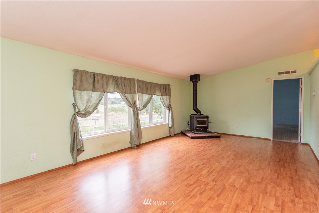 268 Sareault Road Toledo, WA 98591 - Photo 6 of 25 a view of empty room with wooden floor and fan