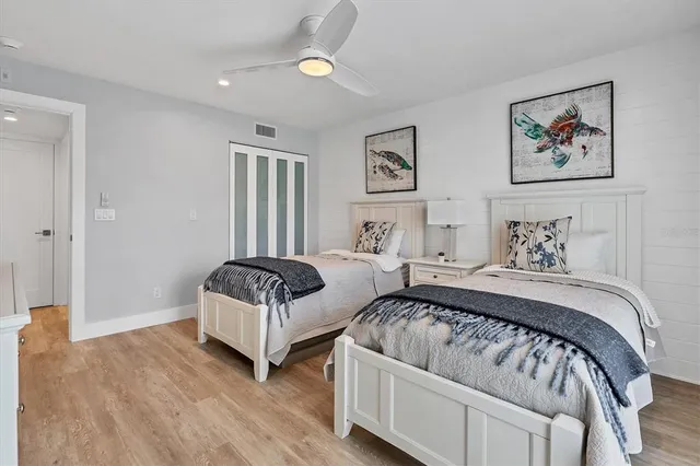 a bedroom with a bed and a painting on the wall