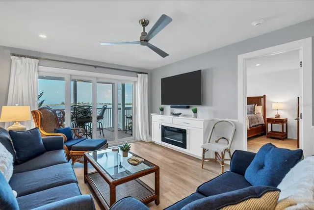 a living room with furniture flat screen tv and a fireplace