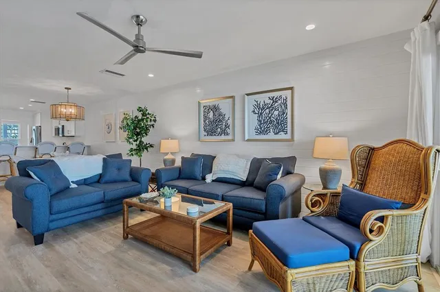 a living room with furniture and a ceiling fan