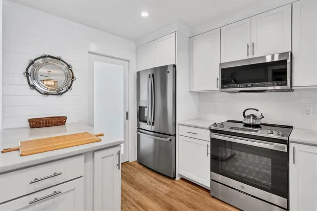 a kitchen with appliances and cabinets